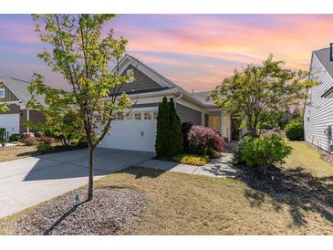 Charming single-story home featuring a manicured lawn and an attached two-car garage at 1206 Areca Way, Durham, NC 27703