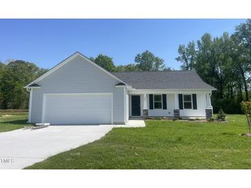 Charming single-story home with gray siding, white trim, and a two-car garage, nestled on a lush green lot at 299 Phil Jack Rd, Dunn, NC 28334