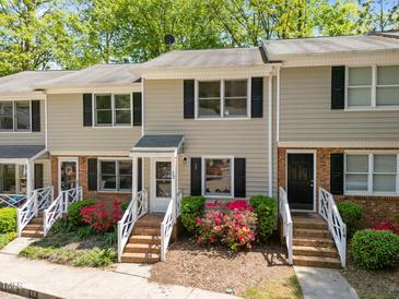 Charming townhome with classic black shutters, brick accents and landscaped entrance at 300 Nc 54 # E3, Carrboro, NC 27510