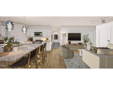 This open-concept living room showcases a kitchen with a granite island and a living area with stylish decor at 307 Burke St, Dunn, NC 28334