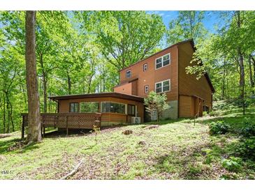 A beautiful two-story home nestled among lush trees creating a private, wooded setting at 3605 Moonlight Dr, Chapel Hill, NC 27516