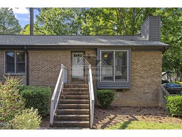 Charming brick home featuring a welcoming entrance with well-maintained landscaping at 500 W Woodcroft Pkwy # 13D, Durham, NC 27713