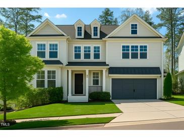 Charming two-story home boasts a well-manicured lawn and an attached two-car garage at 5265 Aleppo Ln, Raleigh, NC 27613