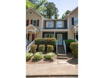 Charming townhome exterior features manicured landscaping and inviting entrance at 861 Dalewood Dr, Raleigh, NC 27610