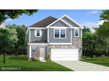 Charming two-story home features a stone and siding facade, green lawn and attached two car garage at 1003 Shovelhead Dr # 2, Durham, NC 27703