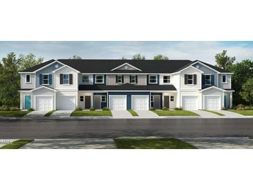 Charming townhomes with white and blue exteriors, complemented by well-manicured lawns and driveways at 10527 Brookside Reserve Rd, Raleigh, NC 27614