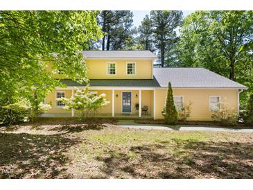 Charming two-story yellow home with a covered front porch and well-maintained landscaping at 109 Bessemer Pl, Durham, NC 27712