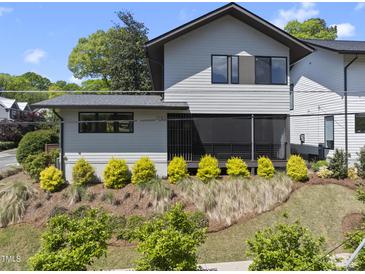 Charming two-story home with grey siding, complemented by well-maintained landscaping at 1101 Norris St, Raleigh, NC 27604