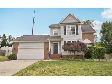 Charming two-story home with gray siding, brick accents, and a well-manicured front lawn at 145 Richmond Park Dr, Cameron, NC 28326