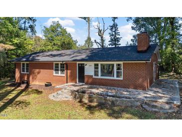 Charming brick home with a dark roof, stone accents, updated windows and landscaping at 2605 Joe Pruitt Rd, Oxford, NC 27565