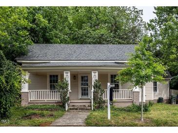 Charming single-story home featuring a cozy front porch, well-maintained lawn, and mature trees at 305 Freeman St, Raleigh, NC 27601