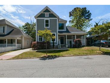 Charming two-story home with gray siding, white trim, covered porch, and mature trees at 314 Gray Ave, Durham, NC 27701