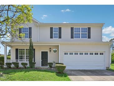 Charming two-story home featuring classic curb appeal with a well-manicured lawn and attached two-car garage at 3604 Rivermist Dr, Raleigh, NC 27610