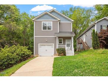 Charming two-story home with a one-car garage and beautifully landscaped front yard at 419 E East Hinton St, Clayton, NC 27520