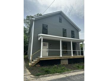 Charming two-story home featuring gray siding, a covered porch, and new construction at 427 Lakeland St, Durham, NC 27701