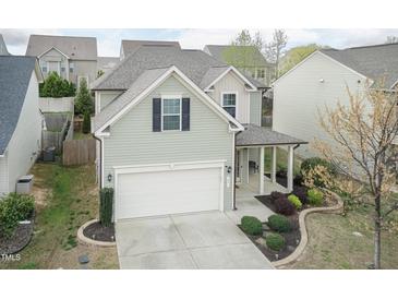 Charming home features a front-facing garage, covered porch, and manicured landscaping at 45 Davelyn Ct, Garner, NC 27529