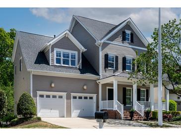 Charming two-story home featuring a two-car garage and inviting front porch with black shutters at 5605 Cary Glen Blvd, Cary, NC 27519