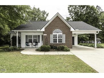 Charming brick and siding home featuring a well-manicured lawn and an inviting carport at 732 Westview Ct, Nashville, NC 27856