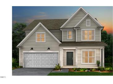 Inviting two-story home featuring neutral siding, a covered front porch, and an attached two-car garage at 760 Bachelor Gulch Way, Apex, NC 27523
