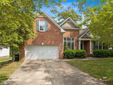 Charming brick home featuring an attached two-car garage and lush landscaping at 107 Weslyn Trace Dr, Durham, NC 27703