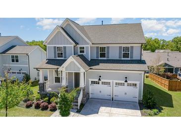 Beautiful two-story home featuring a two car garage and a charming covered front porch at 108 Sunburst Dr, Durham, NC 27705
