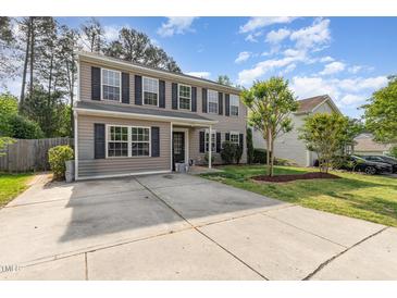 Charming two-story home featuring neutral siding, black shutters, and a well-maintained front yard at 2024 Spring Creek Dr, Durham, NC 27704