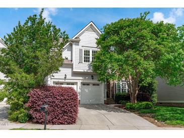 Charming home with a two-car garage, mature trees, and a well-manicured lawn at 2832 Cameron Pond Dr, Cary, NC 27519