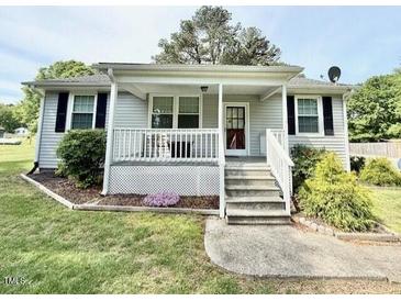 Charming home with covered porch, front lawn, and easy access with minimal stairs at 309 19Th St, Butner, NC 27509