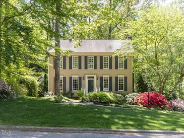 Charming two-story home with a well-manicured lawn and mature trees at 315 King George Loop, Cary, NC 27511