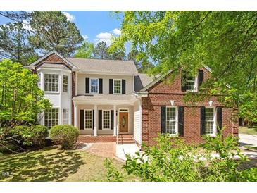 Charming two-story home with a brick and siding exterior, complemented by a well-manicured front yard at 4012 Graham Newton Rd, Raleigh, NC 27606