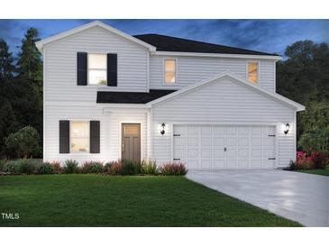 Charming two-story home with a landscaped yard and a two-car garage at 613 White Birch Ln, Angier, NC 27501