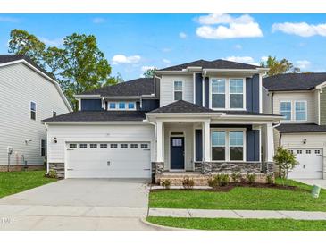 Charming two-story home with a manicured lawn, a two car garage, and stone accents at 745 Aristocrat Ln, Knightdale, NC 27545