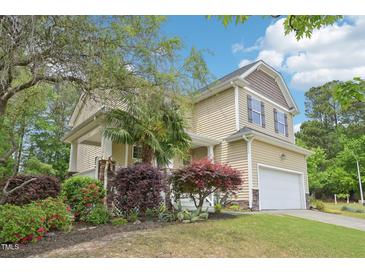 Charming two-story home with well-manicured landscaping, attached two-car garage, and inviting curb appeal at 100 Winterberry Ln, Holly Springs, NC 27540