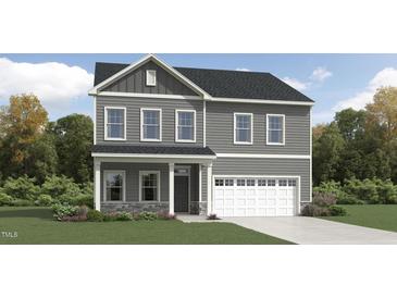 Charming two-story home featuring gray siding, stone accents, and a two-car garage at 1012 Red Roses Ave, Durham, NC 27703