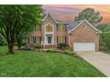 Charming brick home with manicured lawn, mature trees, and inviting front entrance at 111 Murdock Creek Ct, Cary, NC 27519