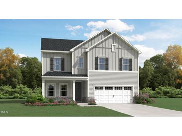 Charming two-story home with a welcoming facade, lush landscaping, and attached garage at 1201 Jade Valley Trl, Raleigh, NC 27610