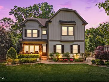 Charming two-story home featuring classic architectural details, manicured landscaping, and inviting front porch at 1209 Kingston Ridge Rd, Cary, NC 27511