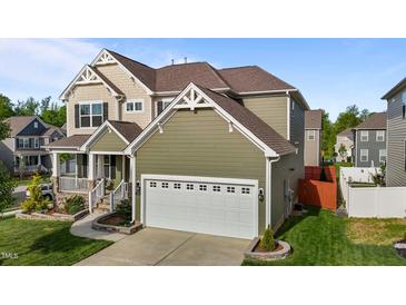 A charming two-story home with a meticulously maintained lawn and a two car garage at 1320 Abington Dr, Mebane, NC 27302