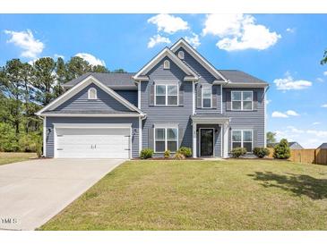 Charming two-story home with a well-manicured lawn and attached two car garage at 30 Dowdy Ct, Youngsville, NC 27596