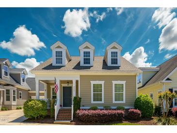 Charming home with dormer windows, a covered porch, and manicured landscaping creates inviting curb appeal at 3827 Heritage Spring Circle Cir, Wake Forest, NC 27587