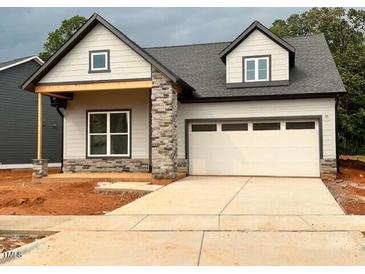 Charming single-Gathering home with a gray exterior, stone accents, and a two-car garage at 40 Wabash St, Pittsboro, NC 27312