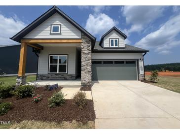 Charming single-Gathering home featuring stone accents and a spacious two-car garage at 40 Wabash St, Pittsboro, NC 27312