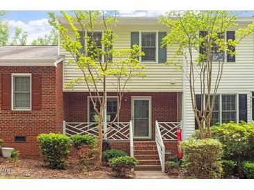 Charming townhouse featuring brick and siding exterior with well-maintained landscaping and inviting entryway at 4617 Fawnbrook Cir, Raleigh, NC 27612