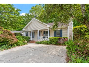 Charming single-story home featuring a well-manicured front yard and cozy front porch area at 5420 Royal Troon Dr, Raleigh, NC 27604
