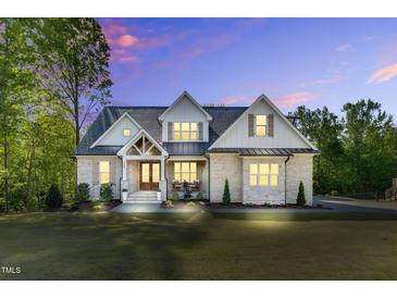Stunning two-story home boasts a brick facade, gabled roof, and a well-manicured lawn at 669 Balmoral St, Clayton, NC 27520