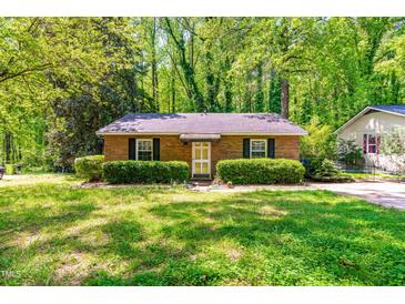 Charming brick home with green shrubs adding curb appeal at 7313 Longstreet Dr, Raleigh, NC 27615