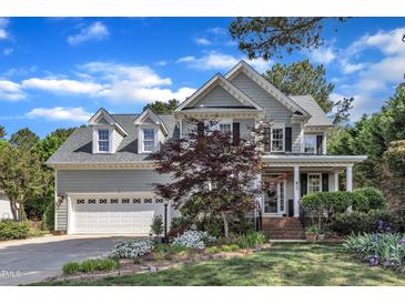 Charming two-story home features a manicured front yard and attached two-car garage at 733 Hadrian Dr, Garner, NC 27529