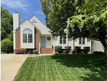 Charming home featuring a well-manicured lawn, inviting entryway, and blossoming landscaping at 9404 Dawnshire Rd, Raleigh, NC 27615