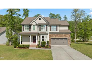 Charming two-story home with stone accents, manicured lawn, and neutral-toned siding at 130 Hilldebrant Dr, Franklinton, NC 27525