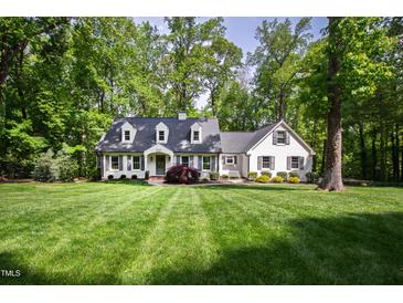 Charming white-painted home with a manicured lawn and mature trees at 202 Homestead Dr, Cary, NC 27513